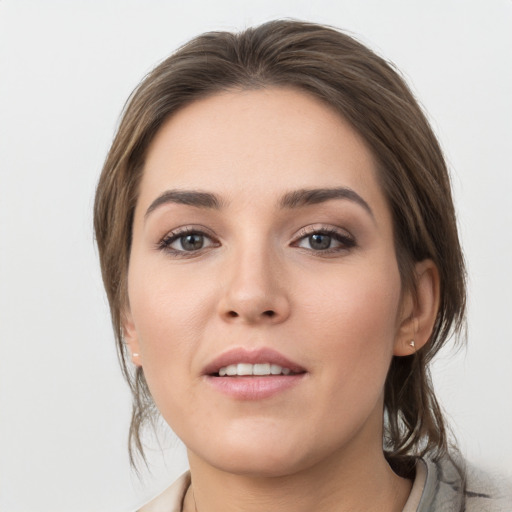 Joyful white young-adult female with medium  brown hair and grey eyes