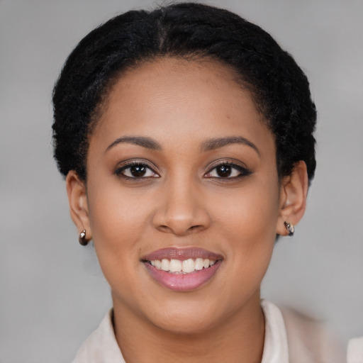 Joyful black young-adult female with short  brown hair and brown eyes