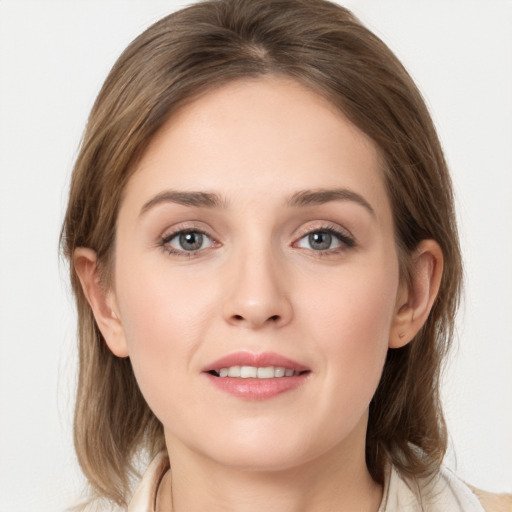 Joyful white young-adult female with medium  brown hair and grey eyes