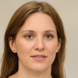 Joyful white adult female with long  brown hair and green eyes