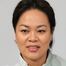 Joyful white adult female with medium  brown hair and brown eyes