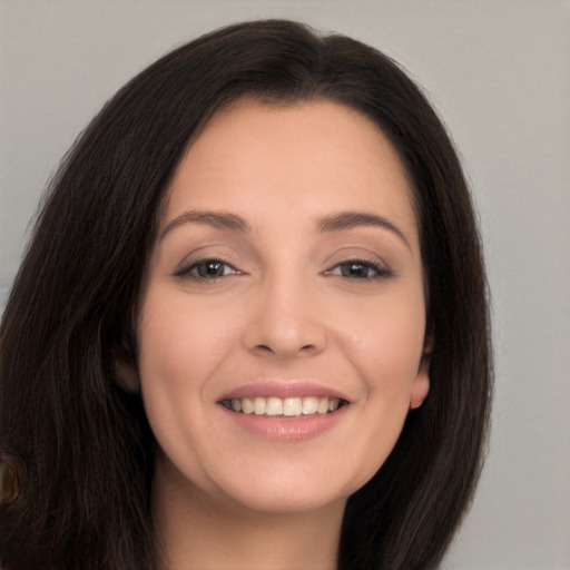 Joyful white young-adult female with long  brown hair and brown eyes