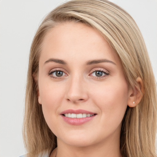 Joyful white young-adult female with long  brown hair and blue eyes