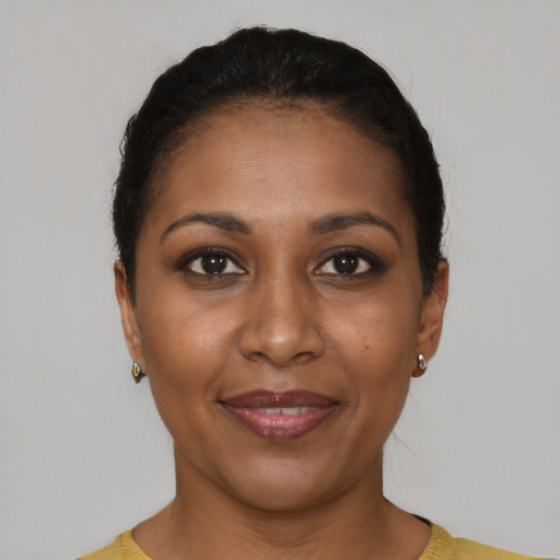 Joyful black young-adult female with short  brown hair and brown eyes