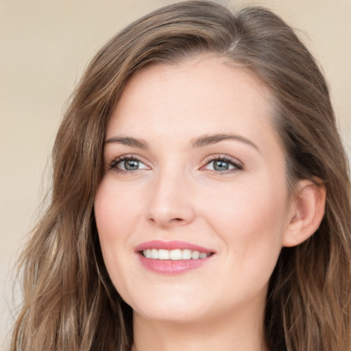 Joyful white young-adult female with long  brown hair and green eyes