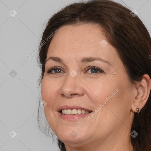 Joyful white adult female with medium  brown hair and brown eyes