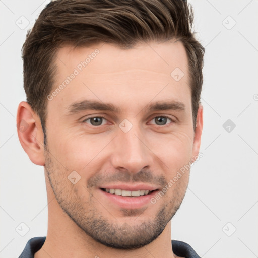 Joyful white young-adult male with short  brown hair and grey eyes