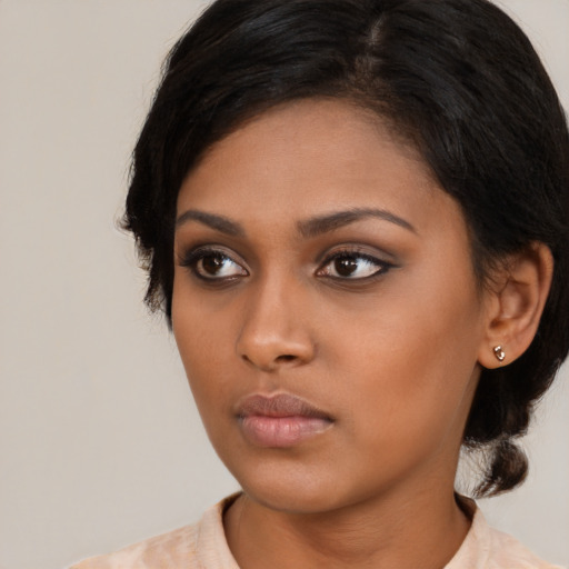 Neutral black young-adult female with medium  black hair and brown eyes