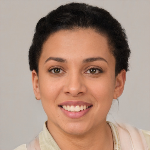 Joyful latino young-adult female with short  brown hair and brown eyes