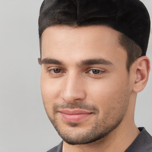 Joyful white young-adult male with short  brown hair and brown eyes