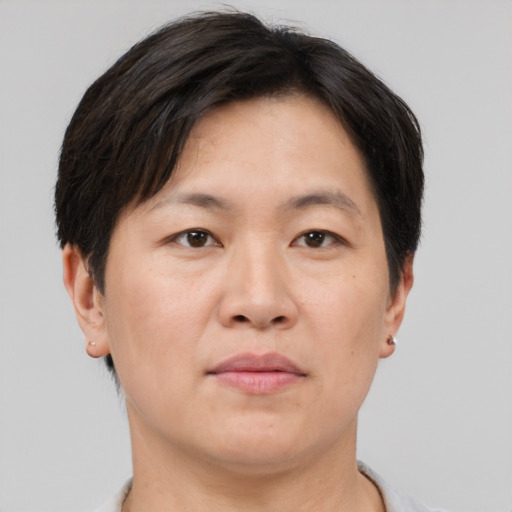 Neutral asian adult female with short  brown hair and brown eyes