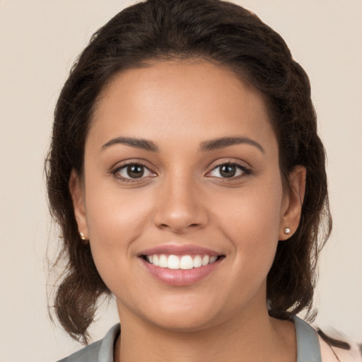 Joyful white young-adult female with medium  brown hair and brown eyes