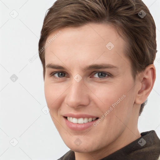 Joyful white young-adult female with short  brown hair and grey eyes