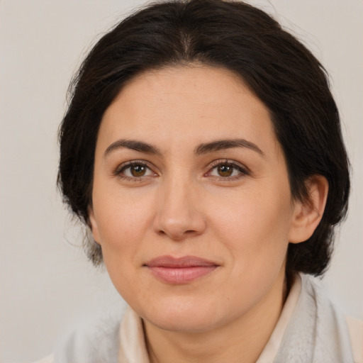 Joyful white adult female with medium  brown hair and brown eyes