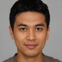 Joyful asian young-adult male with short  black hair and brown eyes