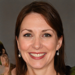 Joyful white adult female with long  brown hair and brown eyes