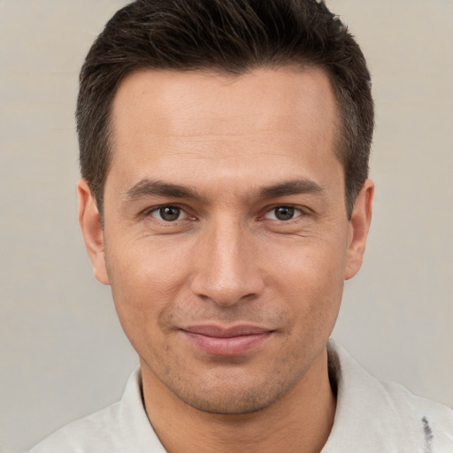 Joyful white young-adult male with short  brown hair and brown eyes