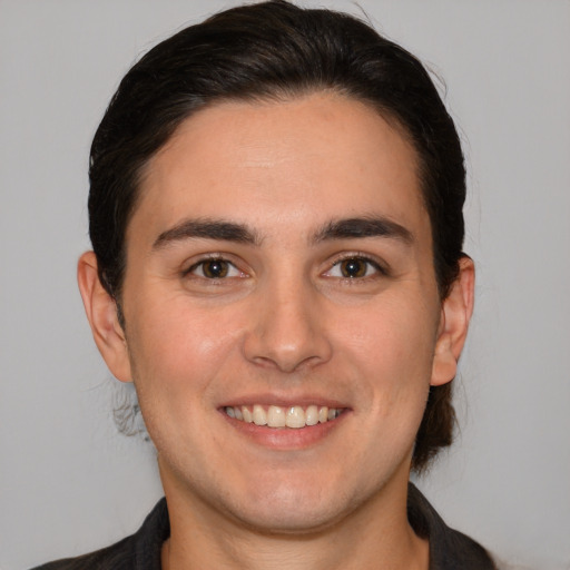 Joyful white young-adult male with medium  brown hair and brown eyes