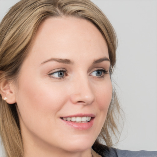 Joyful white young-adult female with medium  brown hair and blue eyes