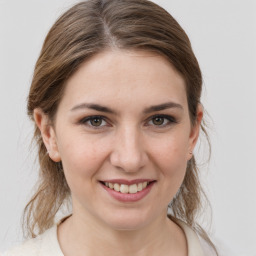 Joyful white young-adult female with medium  brown hair and grey eyes