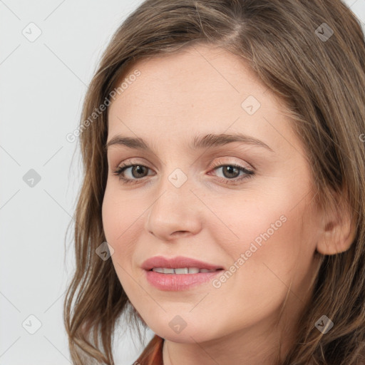 Joyful white young-adult female with long  brown hair and blue eyes