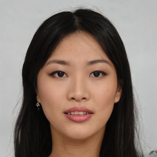Joyful asian young-adult female with long  black hair and brown eyes