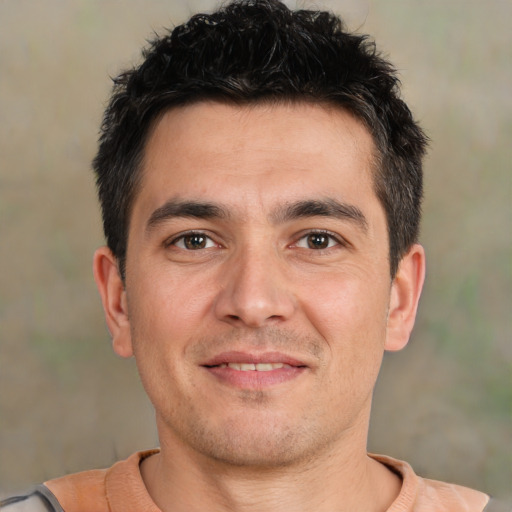 Joyful white young-adult male with short  black hair and brown eyes