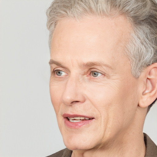 Joyful white middle-aged male with short  brown hair and grey eyes