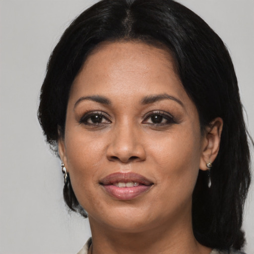 Joyful asian adult female with medium  black hair and brown eyes