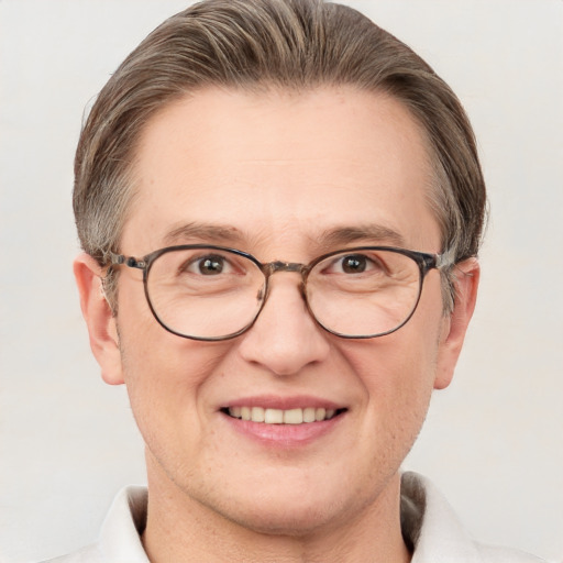 Joyful white adult male with short  brown hair and grey eyes