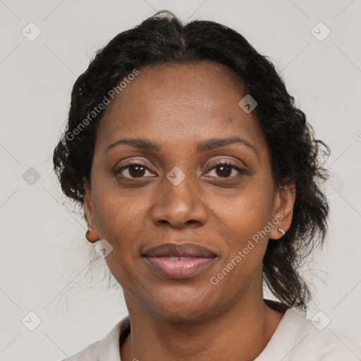 Joyful black adult female with medium  brown hair and brown eyes