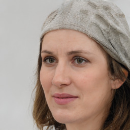 Joyful white adult female with medium  brown hair and grey eyes