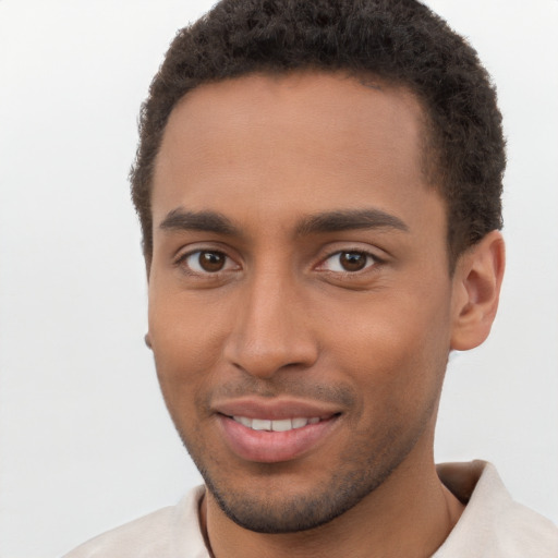 Joyful black young-adult male with short  brown hair and brown eyes