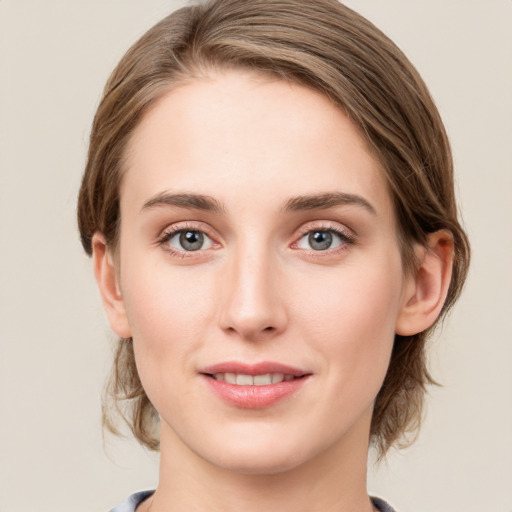 Joyful white young-adult female with medium  brown hair and blue eyes