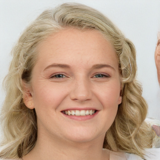 Joyful white young-adult female with long  brown hair and blue eyes