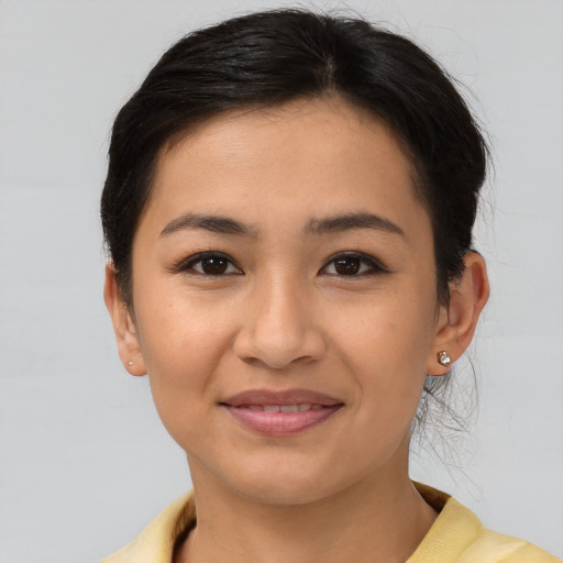 Joyful latino young-adult female with short  brown hair and brown eyes