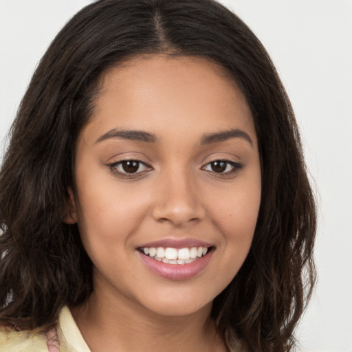 Joyful latino young-adult female with long  brown hair and brown eyes