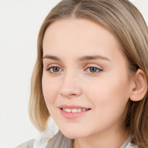 Joyful white young-adult female with long  brown hair and blue eyes