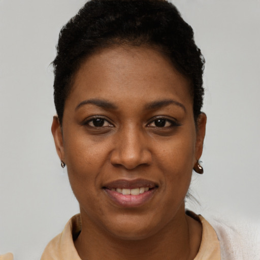 Joyful black young-adult female with short  brown hair and brown eyes