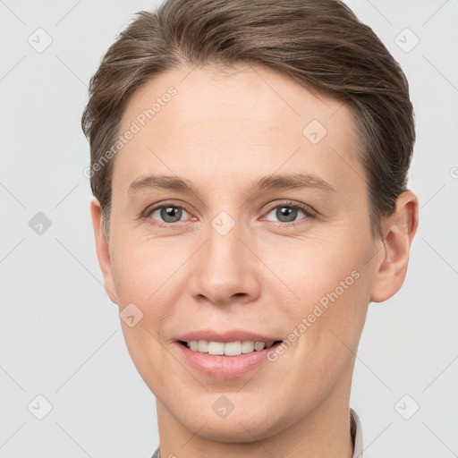 Joyful white young-adult female with short  brown hair and grey eyes