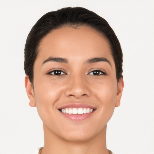 Joyful latino young-adult female with short  brown hair and brown eyes