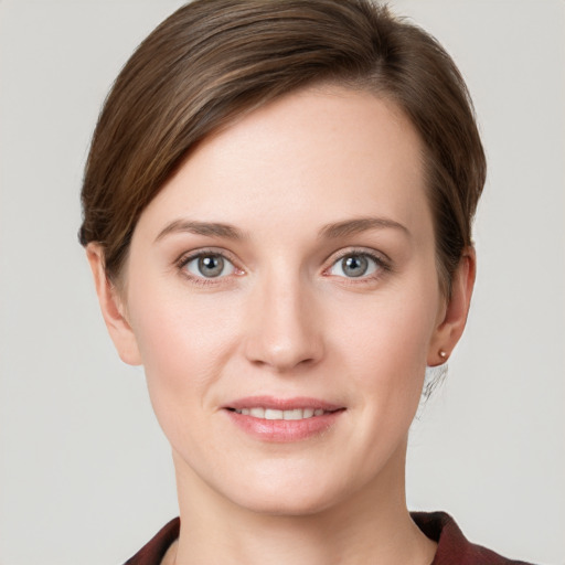 Joyful white young-adult female with short  brown hair and grey eyes