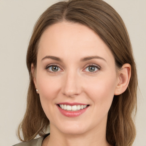 Joyful white young-adult female with long  brown hair and green eyes