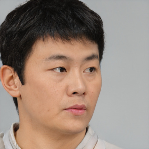 Neutral asian young-adult male with short  brown hair and brown eyes
