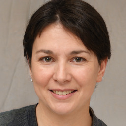 Joyful white adult female with medium  brown hair and brown eyes