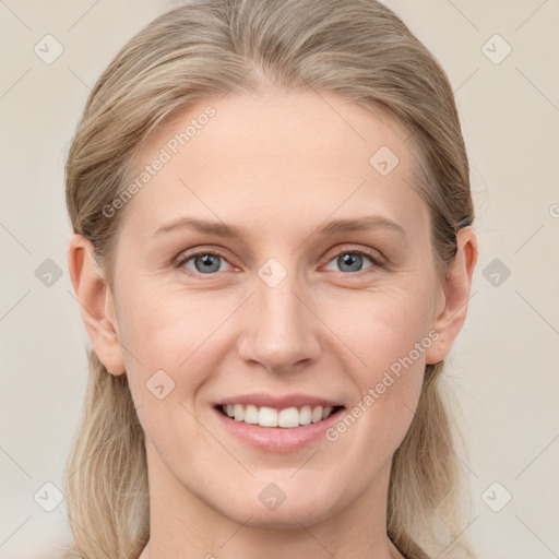 Joyful white young-adult female with long  brown hair and blue eyes