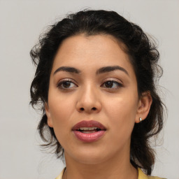 Joyful latino young-adult female with medium  brown hair and brown eyes