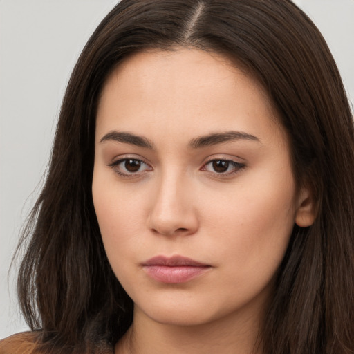 Neutral white young-adult female with long  brown hair and brown eyes