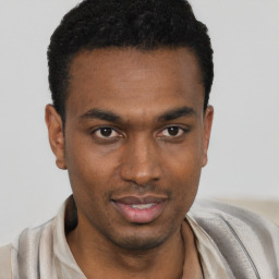 Joyful black young-adult male with short  black hair and brown eyes