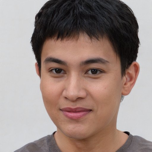 Joyful asian young-adult male with short  brown hair and brown eyes
